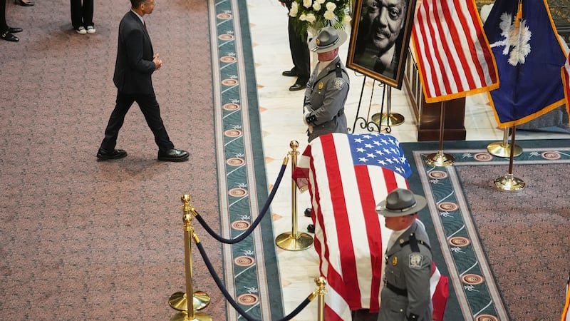 Jesse Jackson Jr. walks toward a picture of his late father inside the South Carolina...