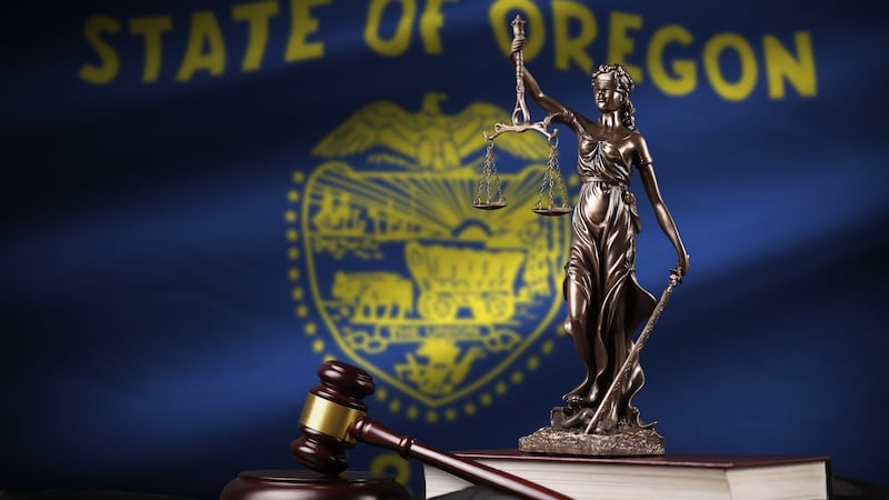 Oregon US state flag with statue of lady justice, constitution and judge hammer on black...