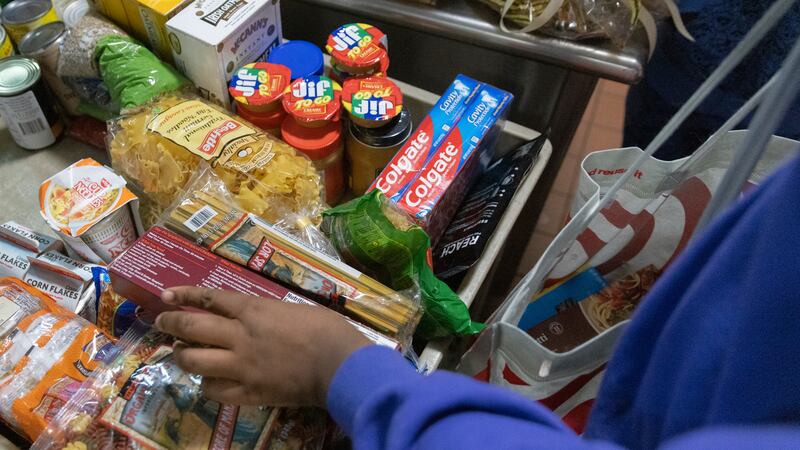 A student from MS 447, The Math & Science Exploratory School, donates food items at Community...