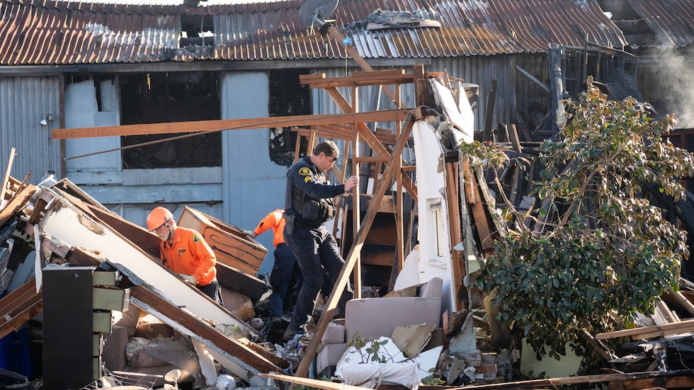 Alameda County Police Officers and Search and Rescue access the aftermath at the site of the...