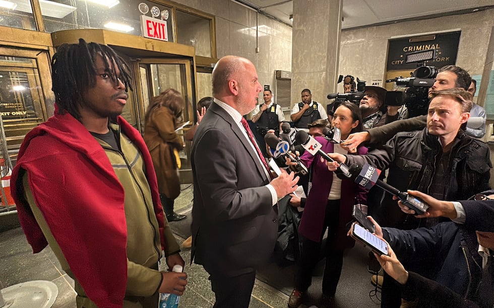 Gusmane Coulibaly, left, listens as his lawyer, George Vomvolakis speaks to members of the...