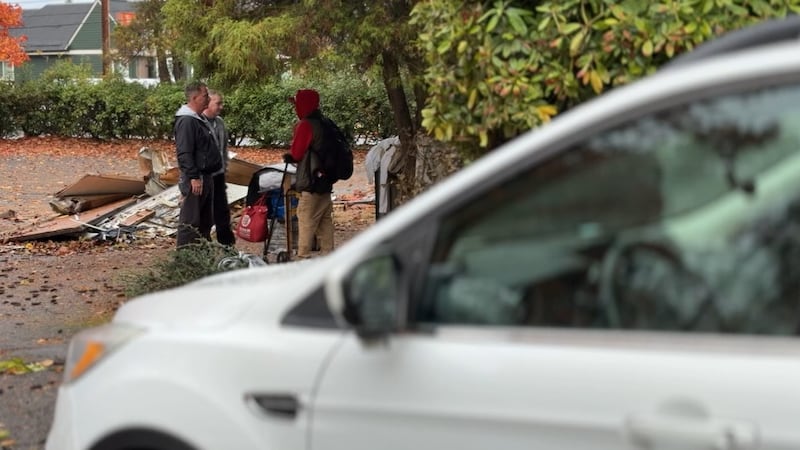 Two members of Gresham Homeless Services speaking with houseless individuals
