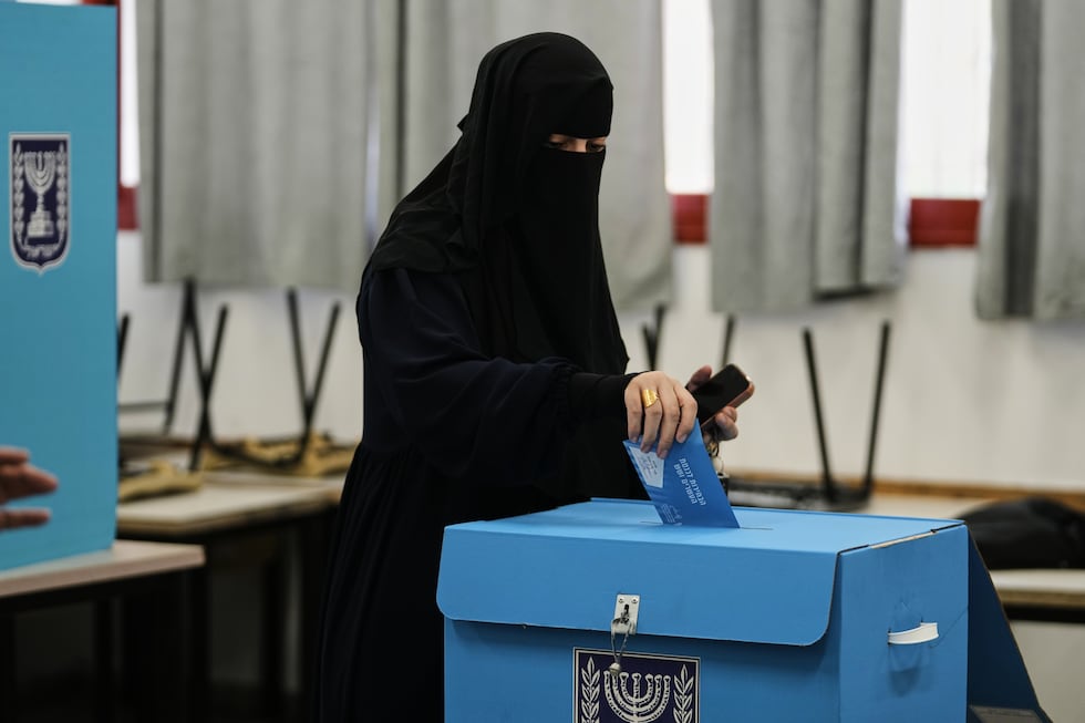 A Palestinian citizen of Israel casts her ballot in the country's general election at a...